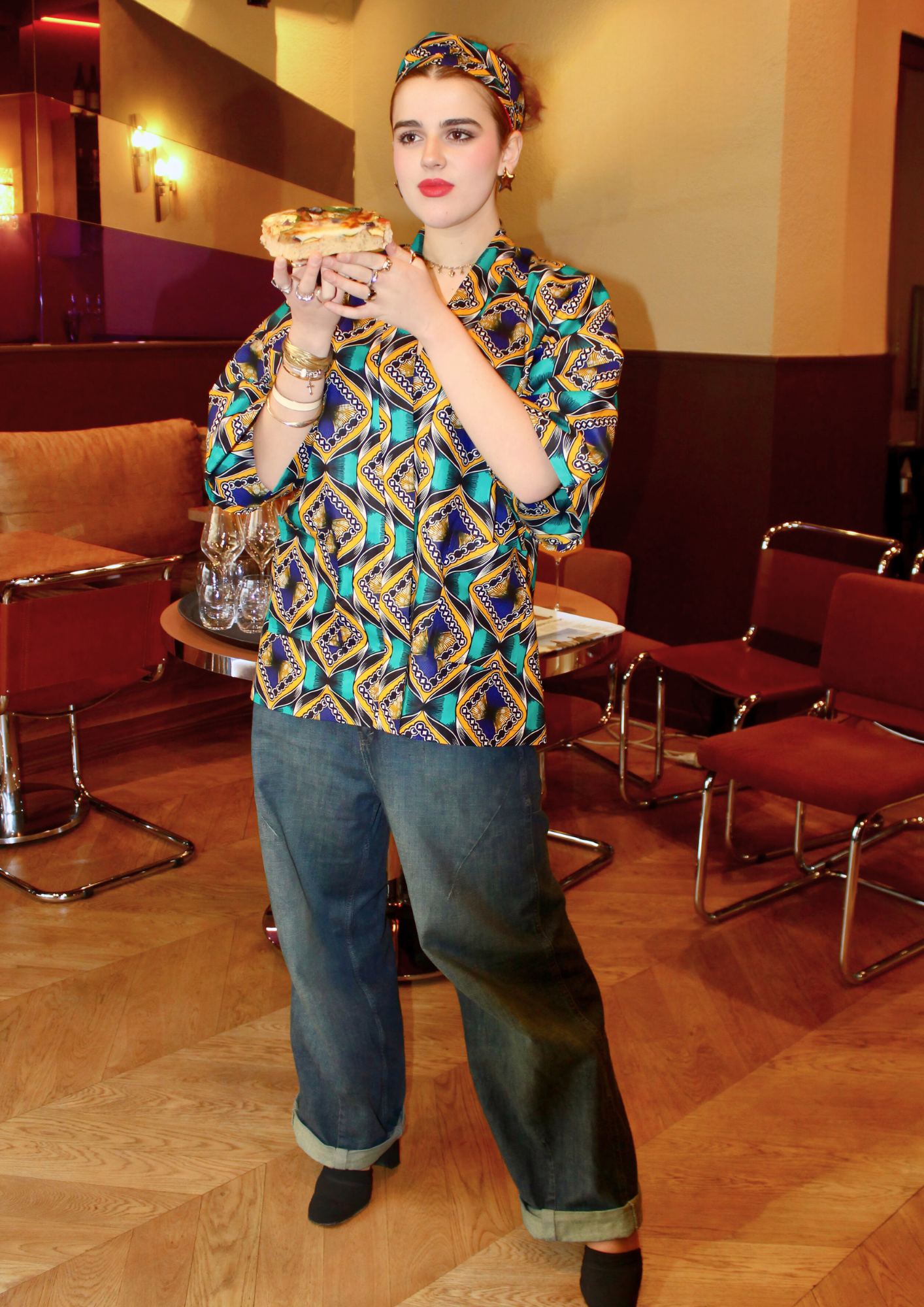 Jeune femme vêtue d'un kimono en wax lifestyle, avec la ceinture du kimono nouée dans les cheveux.