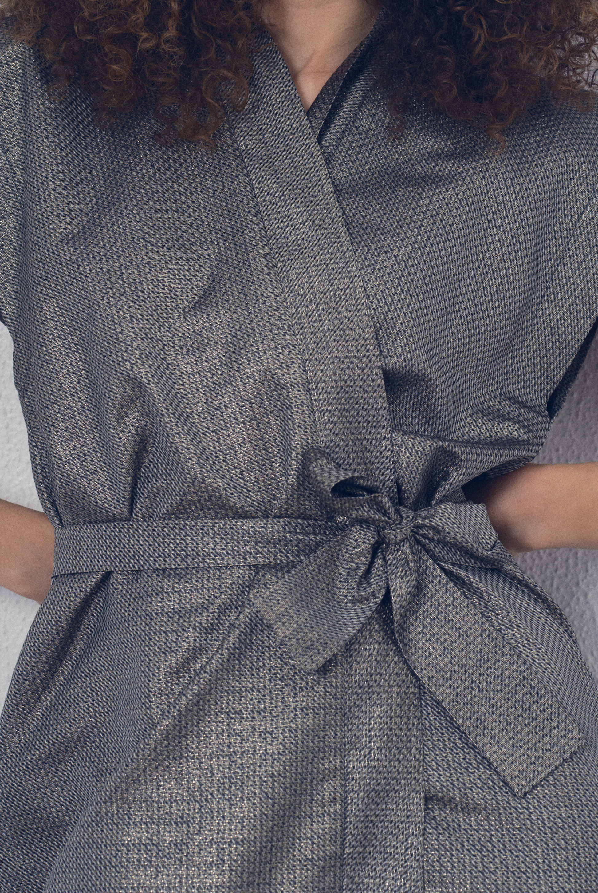 Robe portefeuille en soie lamée gris foncé portée ceinturée, modèle Barbette de la collection Côté Marais par Atelier Sarita