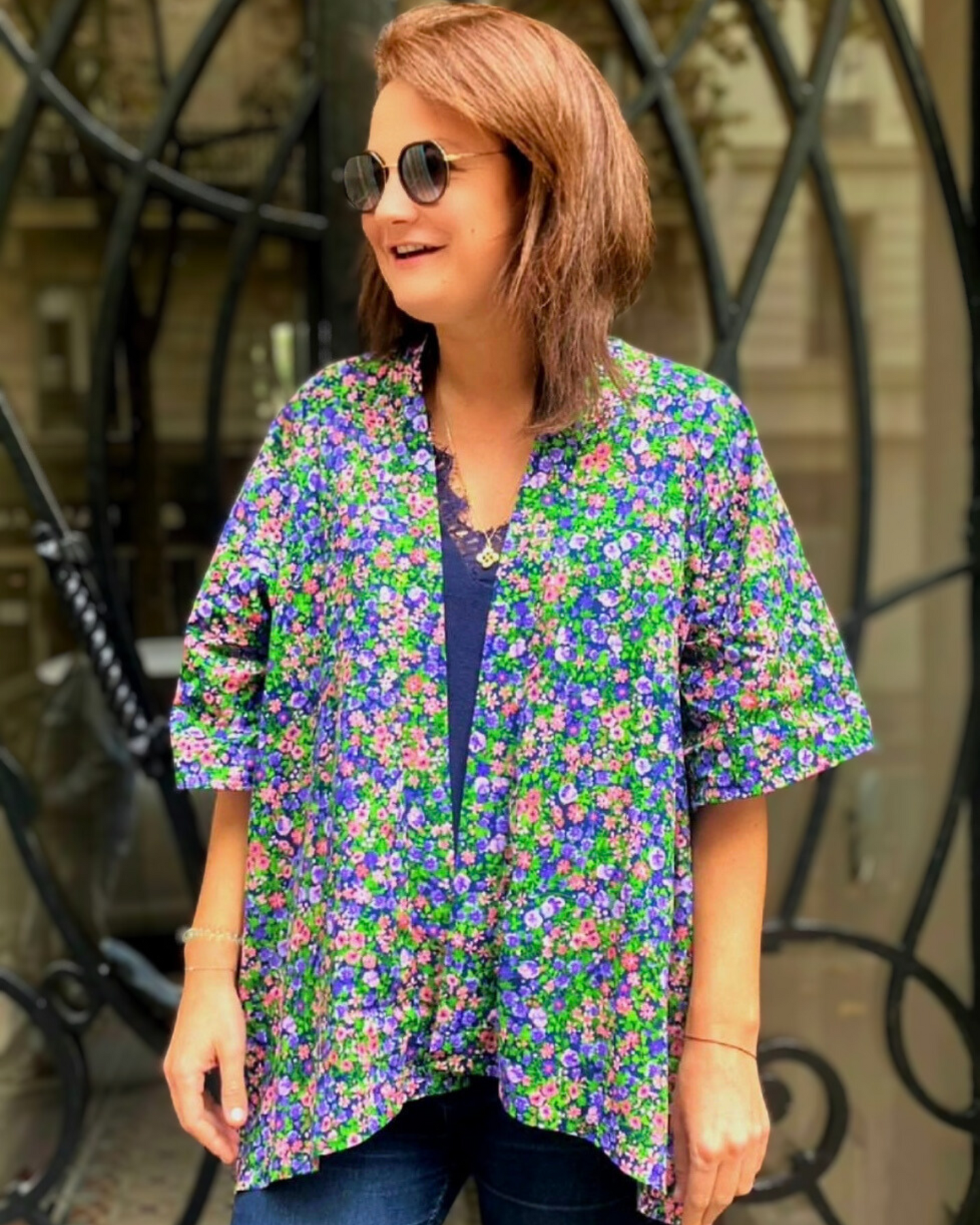 Charlotte, cliente d'Atelier Sarita porte avec enthousiasme dans les rues de Paris son kimono en coton fleuri. 